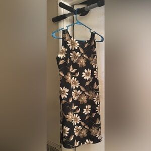 Black dress with gold flowers. Flows past the knees. Ties in the back